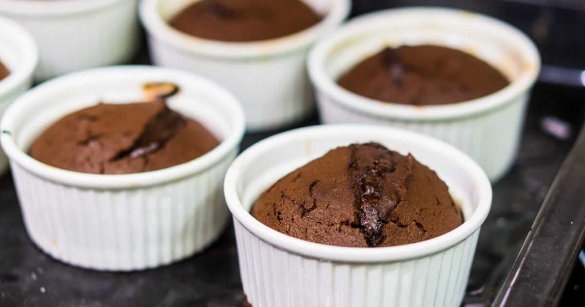 A selective focus shot of chocolate muffins in white cups